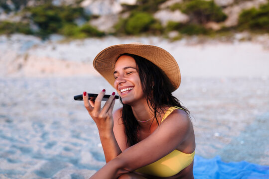 A Young Woman On the Beach Aaving A Call