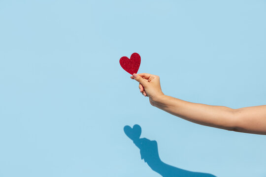 Hand Holding Red Glitter Heart