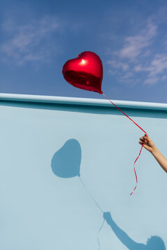  Hand Holding Red Heart Balloon