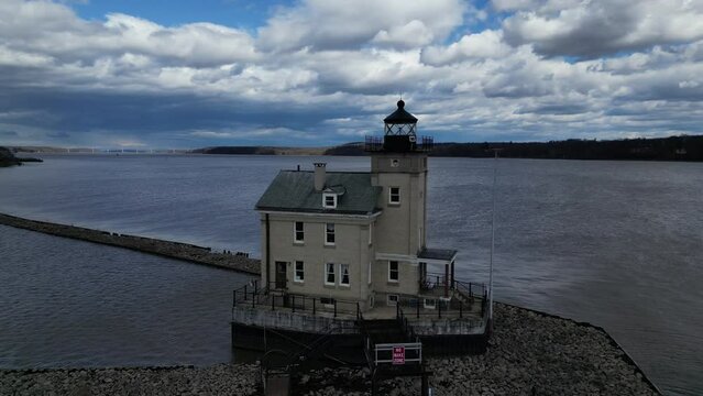 rondout lighthouse aerial footage (drone flying trace tracing circle circling) scenic travel destination in catskills on hudson river creek (light house beacon light guiding boats to shore) maritime