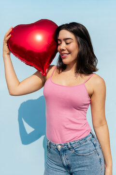Woman Holding a Heart-Shaped Balloon