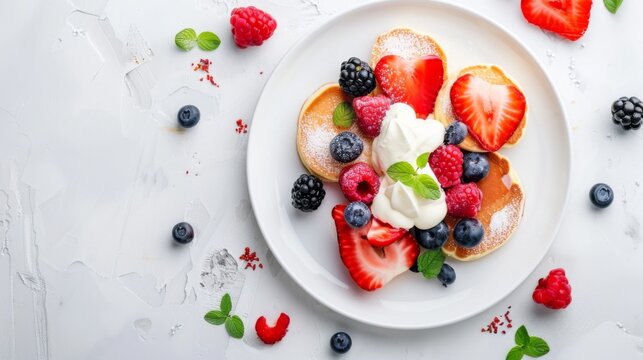 A white plate with heart-shaped pancakes, decorated with berries and cream on top, against a clean background for celebration 