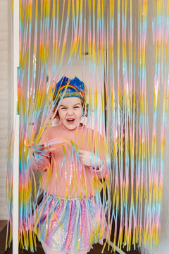 Excited Girl running towards her birthday party with crown.