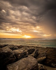Dramatic sunset seascape with approaching thunderstorm clouds.