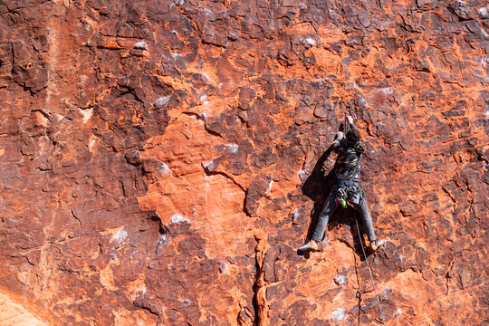 Rock climber outside clipping 