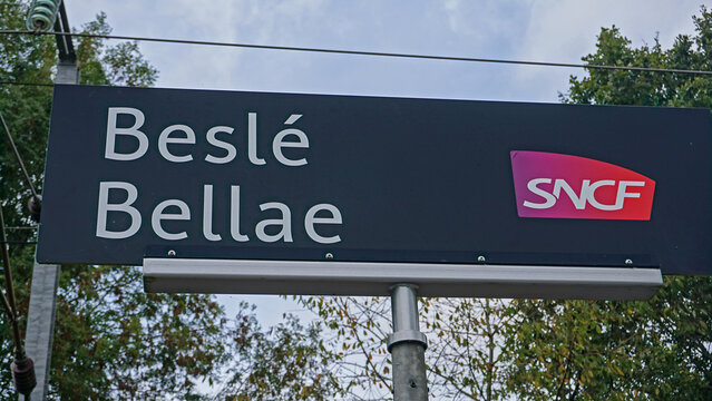 Besle, Brittany, France - September 27, 2023: A bilingual railroad station sign shows a common pattern found in Brittany, where cultures overlap: the French place name above the original Breton name.