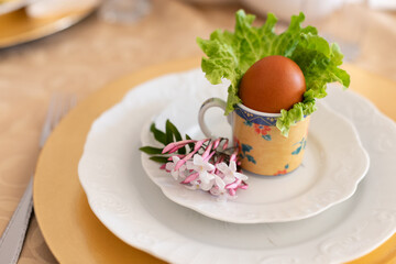 Boiled egg in shell decorating an Easter lunch table