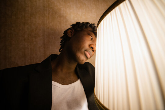 A man examines a switched-on lamp