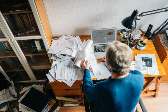Man working in cluttered desk