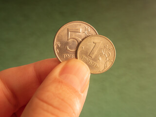 Close-up of Hand Holding Russian One and 5 Ruble Coin