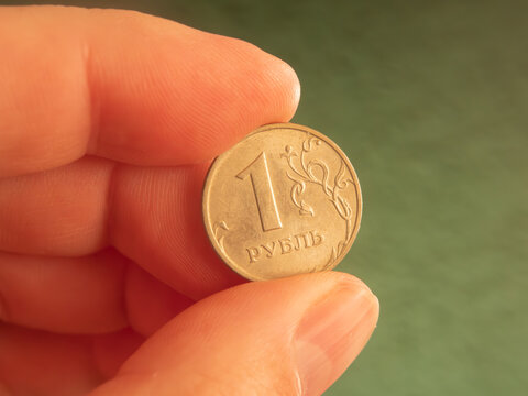 Close-up of a Hand Holding a Russian Ruble Coin