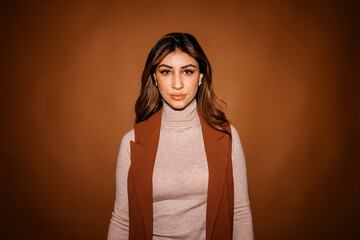 Self assured woman in dark studio