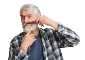 Senior man combing beard with comb on white background
