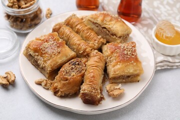Eastern sweets. Pieces of tasty baklava on white table, closeup