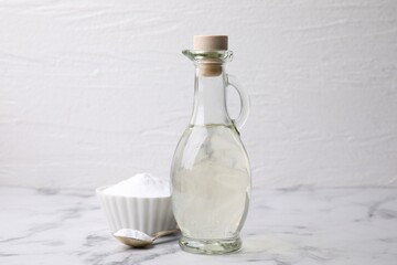 Vinegar and baking soda on white marble table