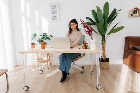 Businesswoman in casual clothes working remotely in workplace