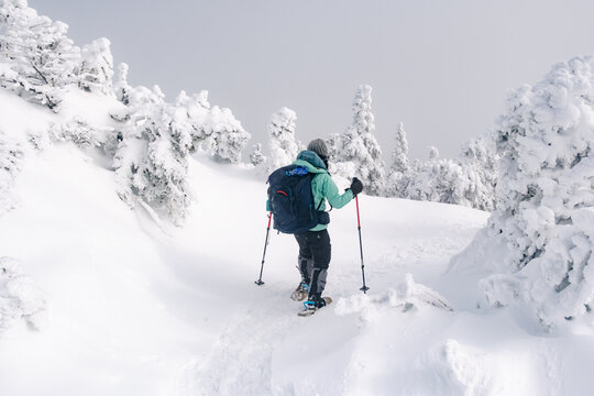 person hiking in frozen landscape in White Mountains NH