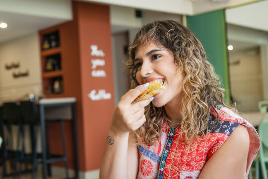 Curly Hair Woman Eating in a Restaurant