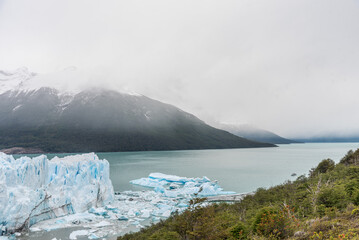 A glacier Perito Moreno with a mountain range in the background