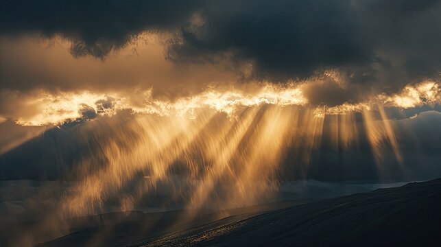Golden rays of light peering through dark clouds