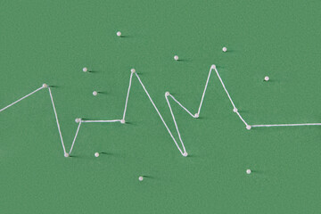 White thread tying around straight pins forming curved continuous line