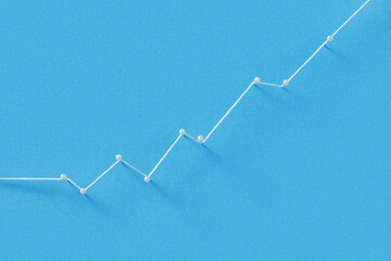 Straight pins with white pearl heads connected with thread