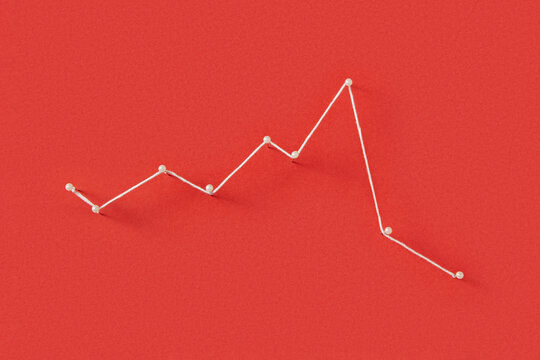 Stationery pins connected with white thread on red paper background