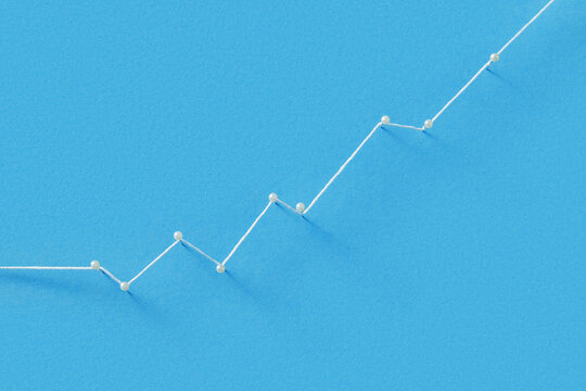 Straight pins with white pearl heads connected with thread