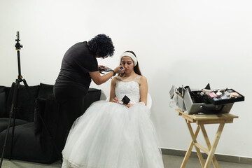 Bride being made up at home.