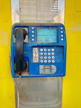Public old dirty telephone box on the wall.