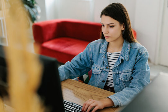 Young female generation z working in office 