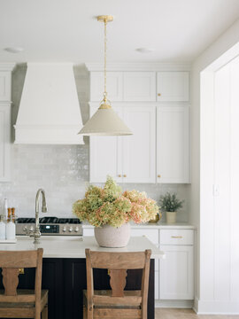 Hydrangeas in a basket on a kitchen counter