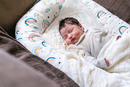 Little newborn baby sleeping in cot