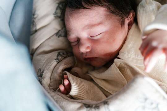 Cute newborn child sleeping in soft with blanket in baby cot