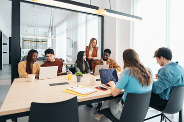 Diverse team strategizing in modern office