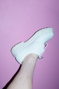 Woman with shin hair wearing shoes. Image normalizing female body hair