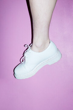 Woman with shin hair wearing shoes. Image normalizing female body hair