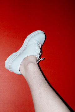 Woman with shin hair wearing shoes. Image normalizing female body hair