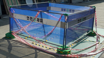 Safety barricade for floor construction on the streets of Seoul, Korea. Text means safety first