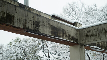 Old cement building structure covered with snow in winter