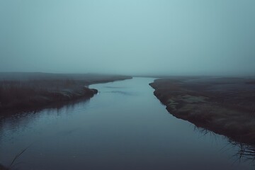 : A wide, empty river flowing through a dull, uninteresting landscape. The water is still and dark.