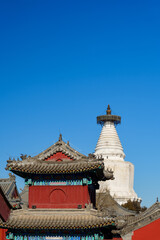 White Pagoda and Red Traditional Building of a Temple in Beijing - obrazy, fototapety, plakaty