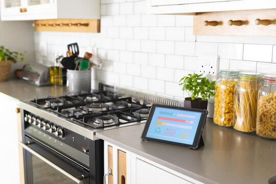 Smart home app energy usage on tablet in kitchen at home