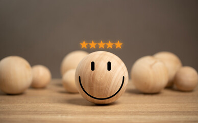 concept of customer satisfaction. smile icon on the wooden ball on the table. customer services...