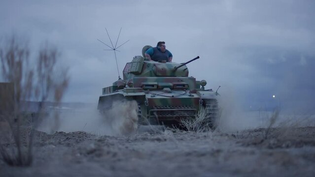 Man riding in smaller tank in epic slow motion - low shot