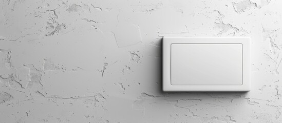 A plain wall with a white light switch placed on it, ready to control the room's lighting