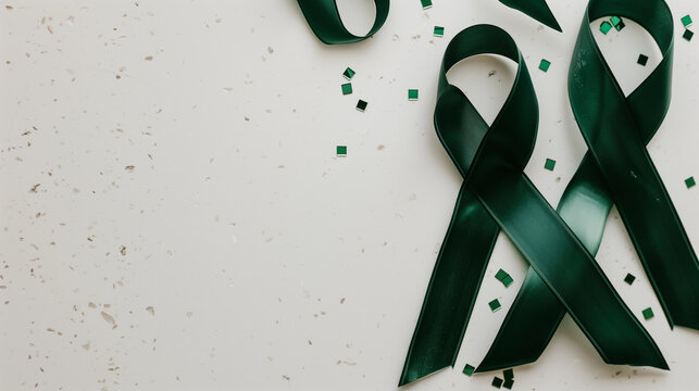 Emerald Green Cancer support ribbon for liver gallbladder bile duct kidney organ donation lyme disease mental health cerebral palsy blank plain background copy space healthcare fundraiser awareness