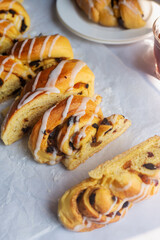 Cut up cinnamon mixed fruit bun on a baking paper