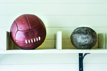 Dark red leather soccer ball and playing ball in retro style