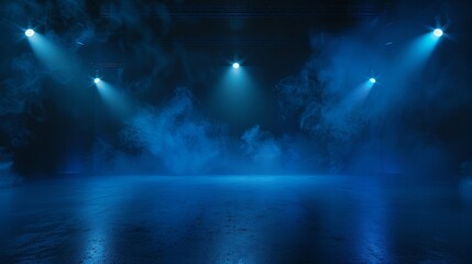 Blue spotlights illuminate an empty stage covered in fog. - obrazy, fototapety, plakaty